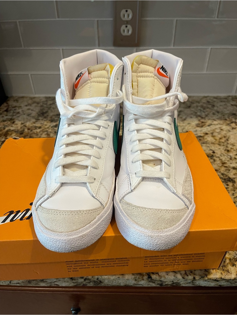 Nike White Mid-Top Sneakers with Green Swoosh and Orange Tongue